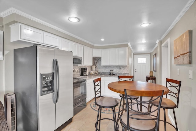 kitchen with sink, light tile patterned flooring, stainless steel appliances, white cabinets, and ornamental molding