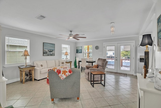 living room with french doors, ornamental molding, light tile patterned flooring, and ceiling fan