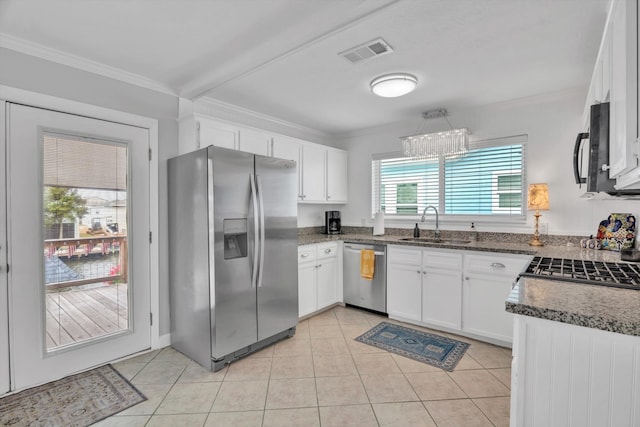 kitchen featuring white cabinetry, crown molding, appliances with stainless steel finishes, and plenty of natural light