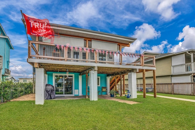 back of property with a wooden deck and a yard