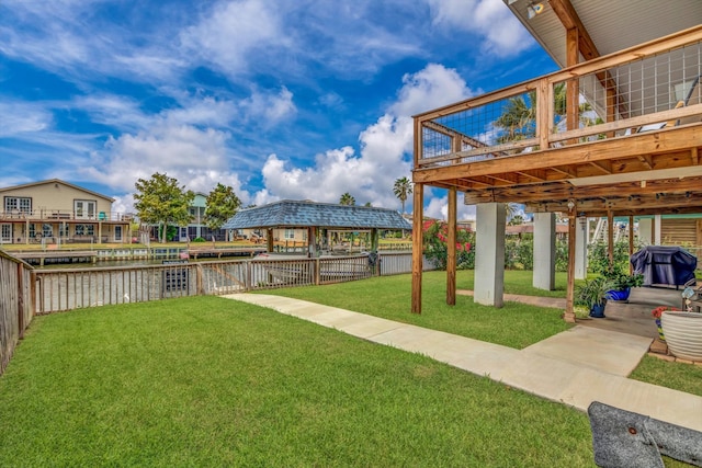 view of yard with a deck with water view