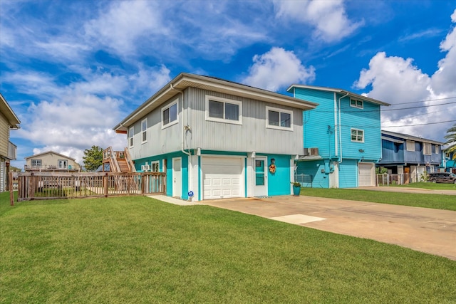 rear view of property featuring a yard and a garage