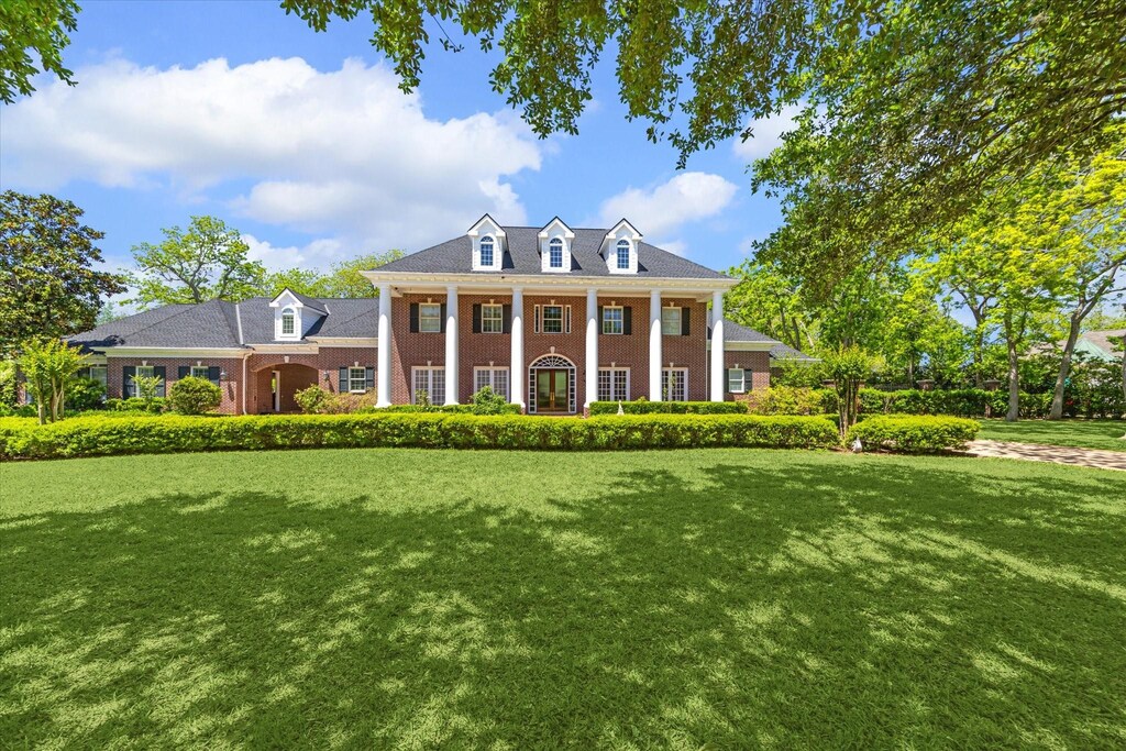 25 Beacon Hill, Sugar Land, TX 77479 - neoclassical home featuring a front lawn, brick siding, and covered porch