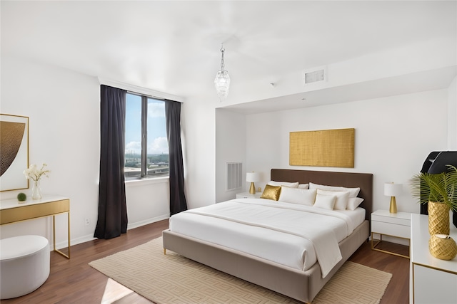 bedroom with hardwood / wood-style flooring