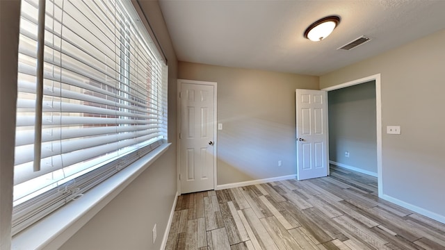 spare room with light wood-type flooring