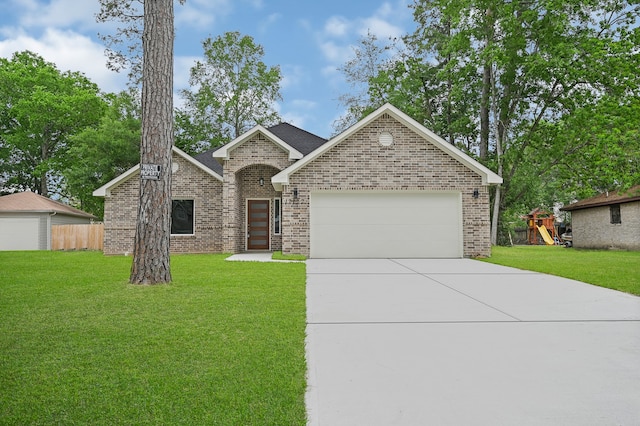 view of front of house with a playground, a front yard, and a garage