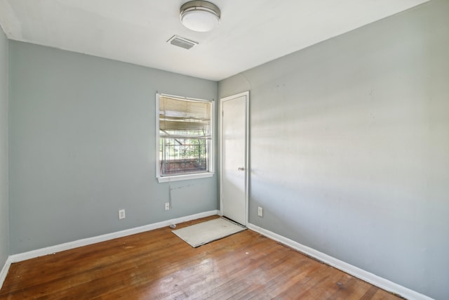 empty room with hardwood / wood-style flooring