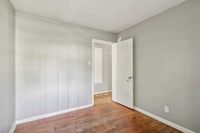 unfurnished room with wood-type flooring