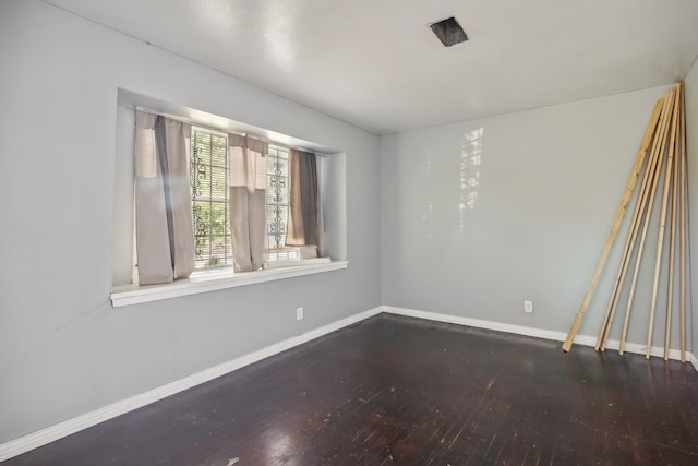 empty room with dark wood-type flooring