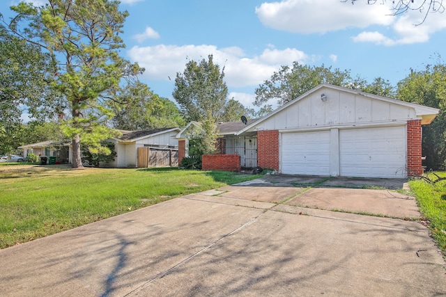 ranch-style house featuring a front lawn and a garage