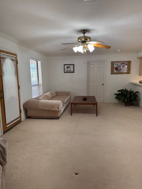 bedroom with crown molding, light colored carpet, and ceiling fan