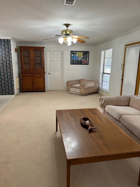 unfurnished living room with light carpet, ornamental molding, and ceiling fan