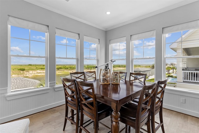 dining room with a water view and a healthy amount of sunlight