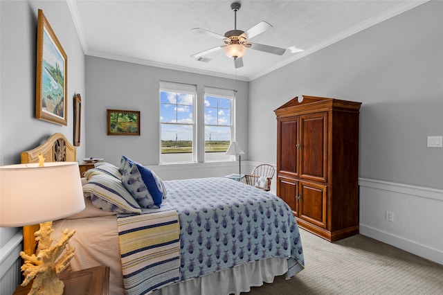 carpeted bedroom featuring ornamental molding and ceiling fan