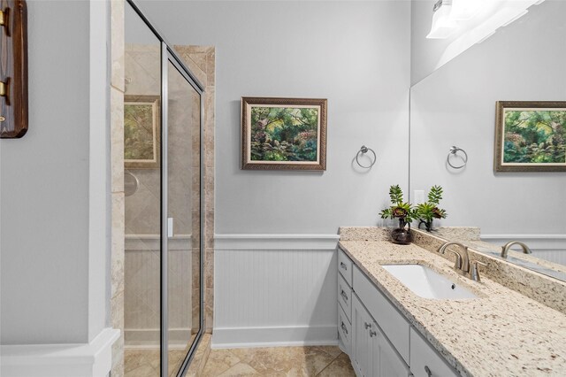 9 Hawkeye, Hitchcock, TX 77563 - bathroom with vanity, a stall shower, wainscoting, and tile patterned flooring