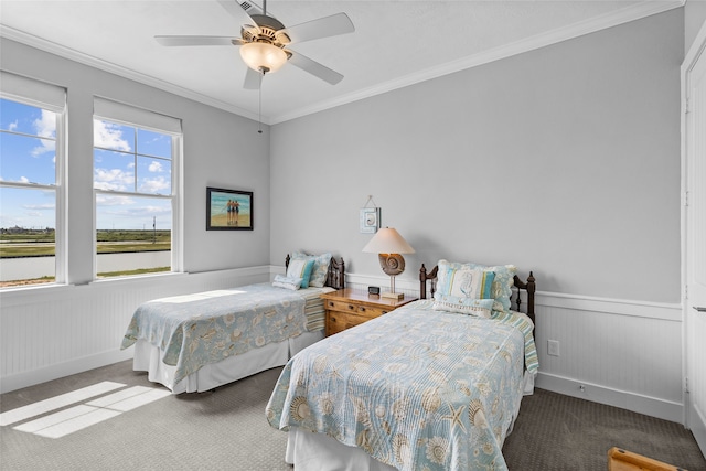 bedroom with carpet floors, ornamental molding, multiple windows, and ceiling fan