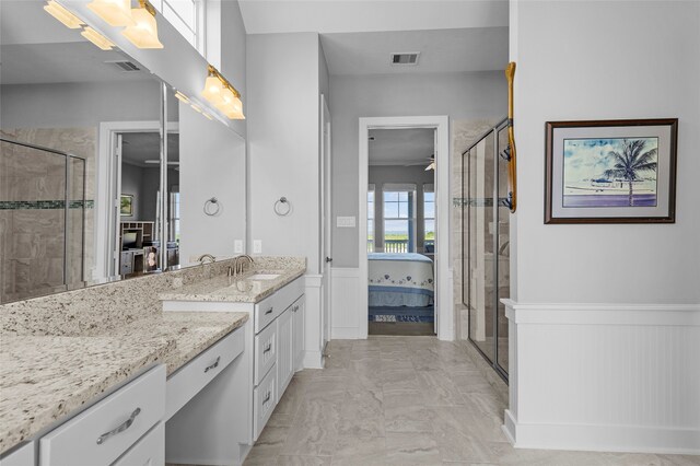 bathroom with ceiling fan, vanity, and a shower with shower door