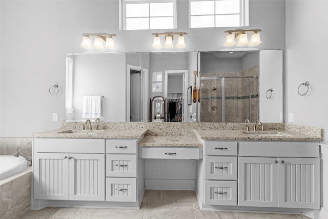 bathroom featuring tile patterned flooring, shower with separate bathtub, and vanity