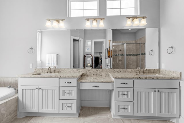 9 Hawkeye, Hitchcock, TX 77563 - full bathroom with a shower stall, two vanities, a bath, and a towering ceiling