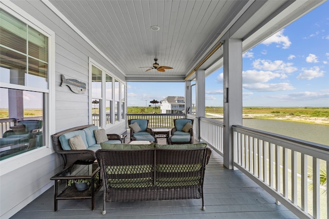 sunroom / solarium featuring ceiling fan