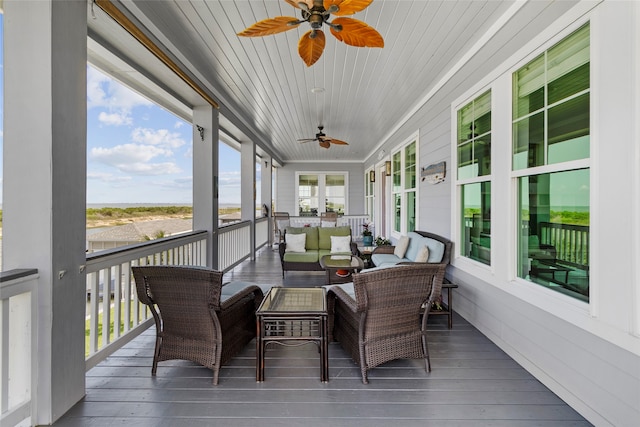sunroom / solarium with ceiling fan, plenty of natural light, and wood ceiling