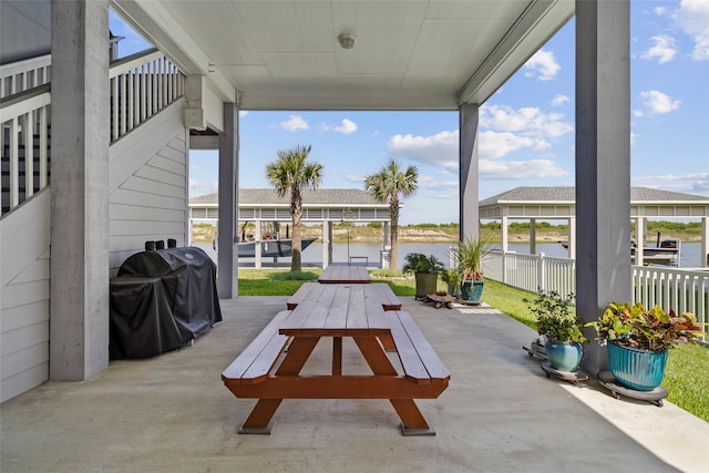 view of patio featuring a water view and area for grilling