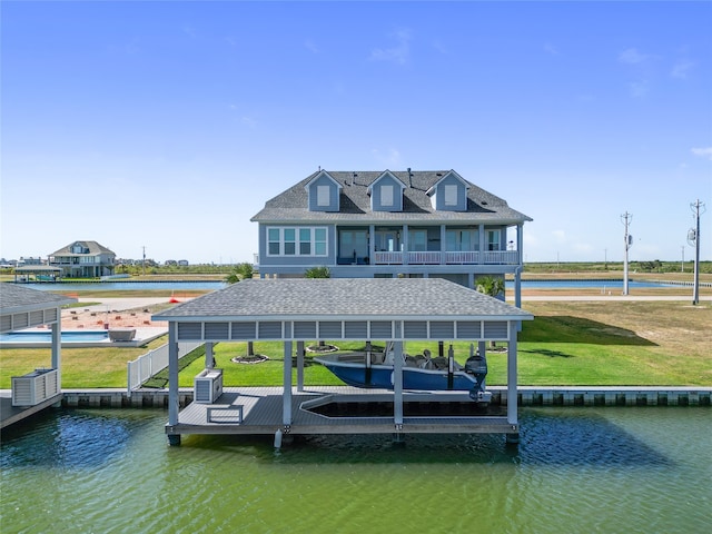 dock area featuring a water view, a balcony, and a lawn