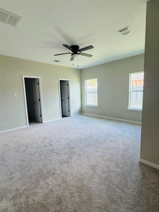 empty room with light carpet and ceiling fan