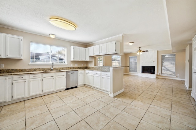 kitchen featuring white cabinets, kitchen peninsula, stainless steel dishwasher, and a wealth of natural light