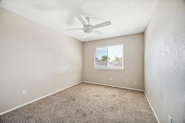 unfurnished room featuring ceiling fan and carpet flooring