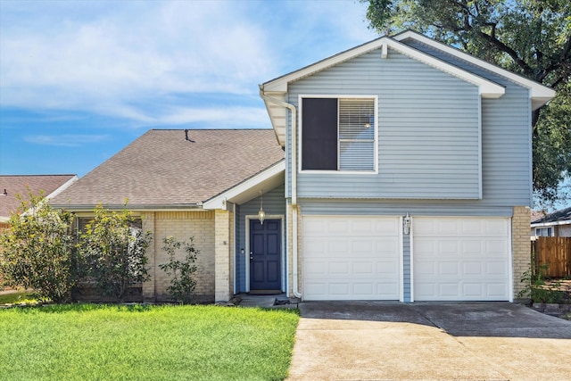 view of front of house with a front yard and a garage