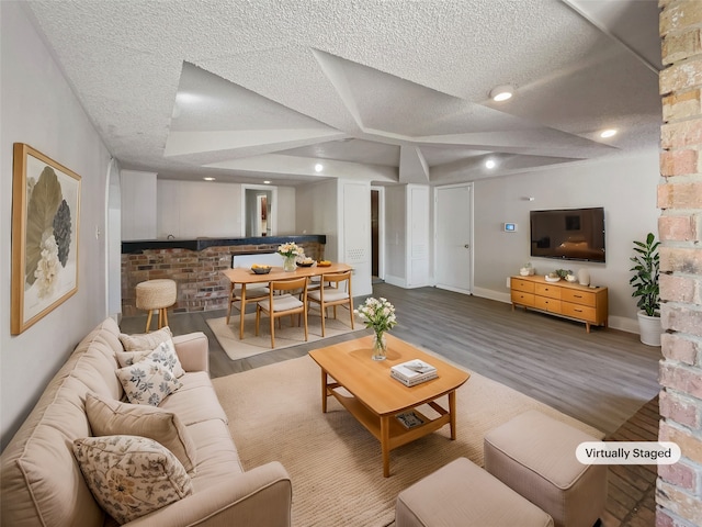 living room with a textured ceiling and hardwood / wood-style floors