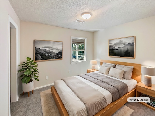 carpeted bedroom featuring a textured ceiling