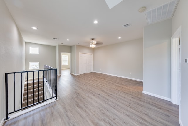 unfurnished room featuring light hardwood / wood-style floors and ceiling fan