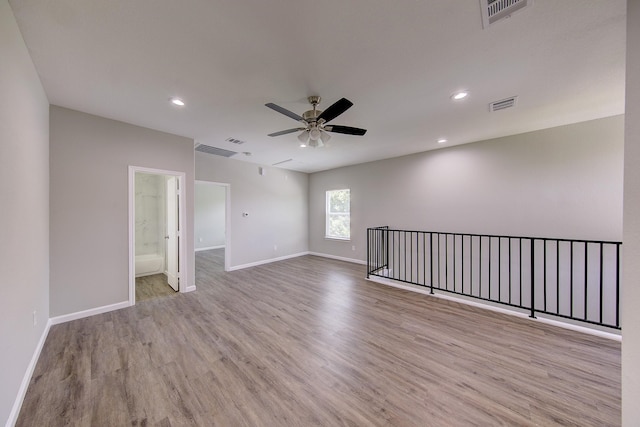 spare room featuring ceiling fan and light hardwood / wood-style floors