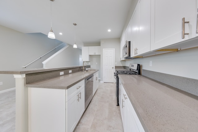 kitchen with sink, stainless steel appliances, light stone countertops, hanging light fixtures, and white cabinetry