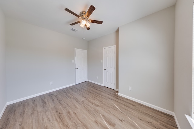 spare room featuring ceiling fan and light hardwood / wood-style floors