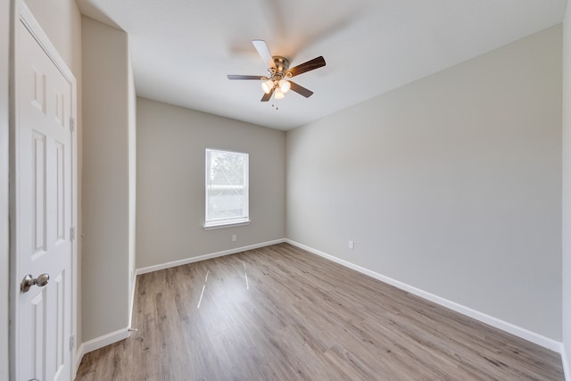 empty room with ceiling fan and light wood-type flooring