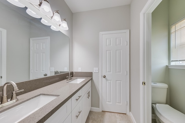 bathroom with tile patterned floors, vanity, and toilet