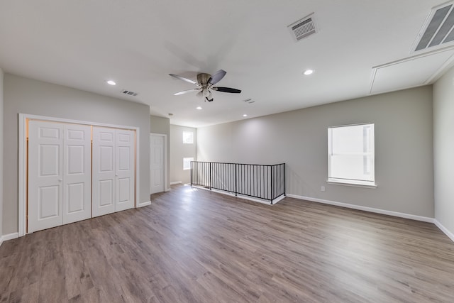 unfurnished room with ceiling fan and light wood-type flooring