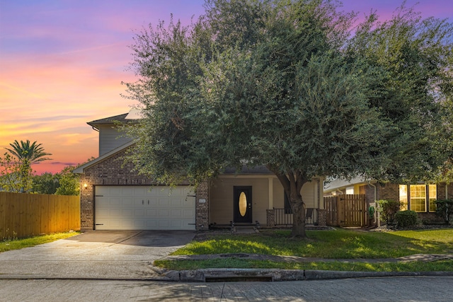 obstructed view of property with a garage and a lawn