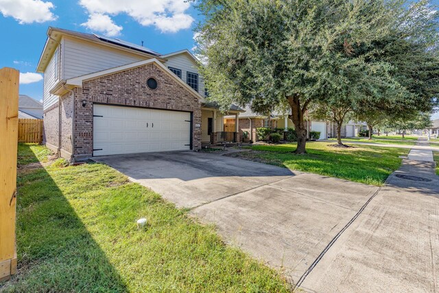 view of front of home featuring a front yard and a garage