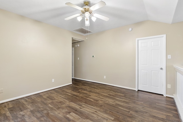 empty room featuring lofted ceiling, ceiling fan, and dark hardwood / wood-style floors