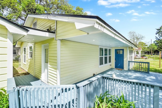 view of side of property with a wooden deck