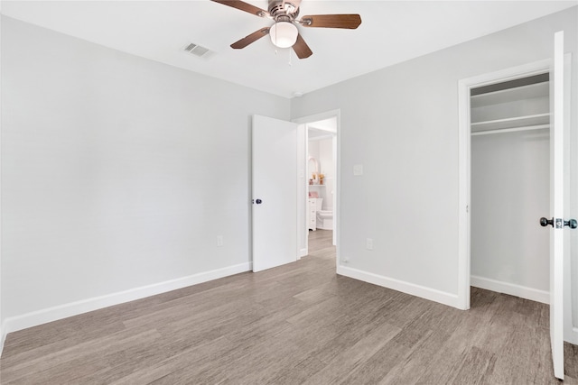 unfurnished bedroom with a closet, light hardwood / wood-style floors, and ceiling fan