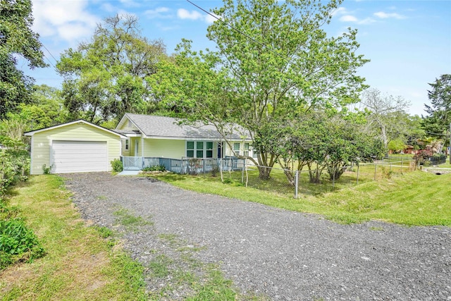 ranch-style house with a garage and a front lawn