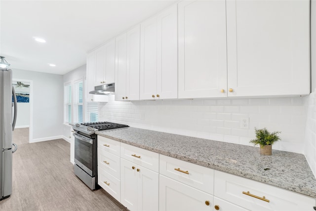 kitchen with light stone counters, light hardwood / wood-style floors, white cabinetry, and stainless steel appliances