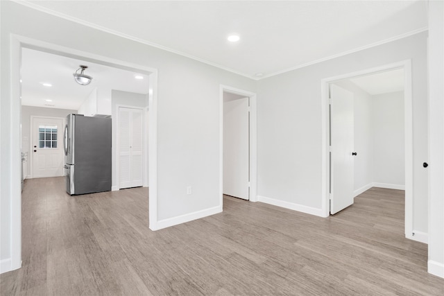 spare room with light hardwood / wood-style flooring and ornamental molding