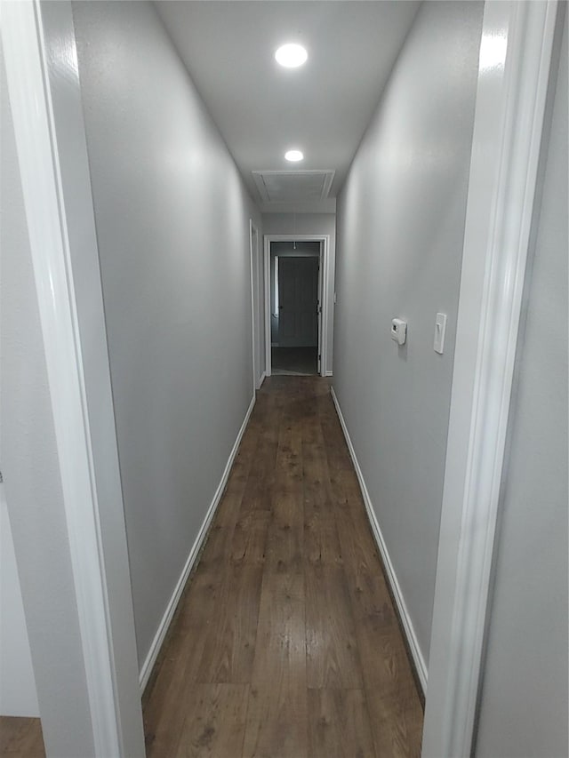 hall with attic access, recessed lighting, dark wood finished floors, and baseboards