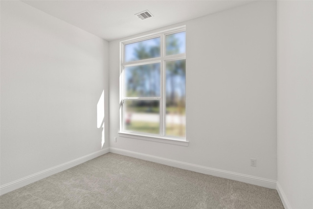 unfurnished room featuring light colored carpet